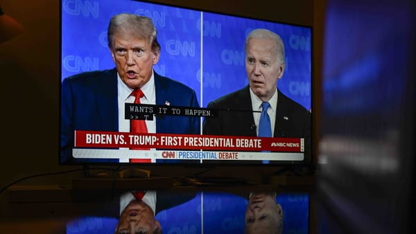 A split screen of Trump and Biden head and shoulders on a TV